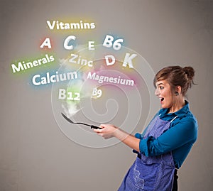 Young woman cooking vitamins and minerals