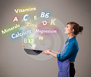 Young woman cooking vitamins and minerals