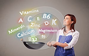 Young woman cooking vitamins and minerals