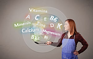 Young woman cooking vitamins and minerals