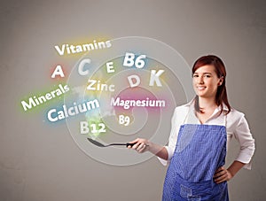 Young woman cooking vitamins and minerals