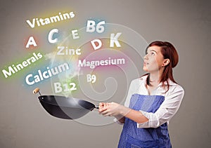 Young woman cooking vitamins and minerals