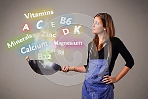 Young woman cooking vitamins and minerals