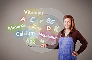 Young woman cooking vitamins and minerals