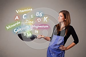Young woman cooking vitamins and minerals