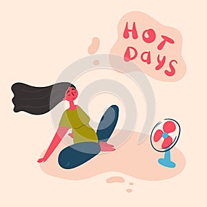 A young woman cools under a fan on hot summer day