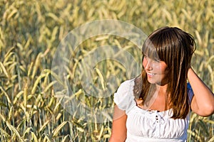 Young woman in corn field enjoy sunset