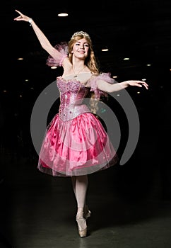Young woman cosplayer wearing pink dress