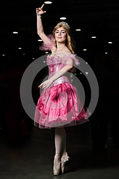 Young woman cosplayer wearing pink dress