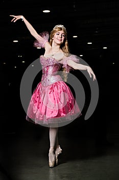 Young woman cosplayer wearing pink dress