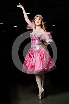 Young woman cosplayer wearing pink dress