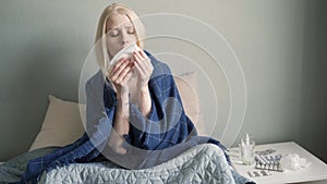 Young woman coughing in bedroom. Close up of sick girl cough cold. Female person face with flu symptoms.