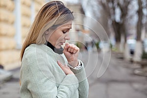 Young woman coughing feeling bad