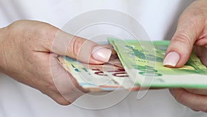 Young woman counting Euro bills in hands, closeup view