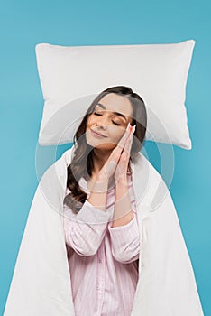 young woman covered in white duvet