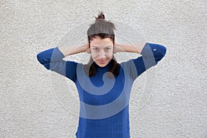 Mujer joven cubierta orejas manos 