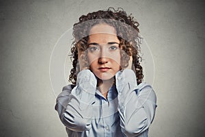 Young woman covering her ears with hands