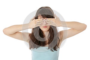 Young woman covering her eyes