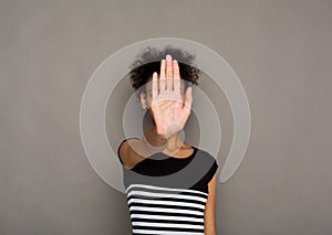 Young woman covering her face with palm