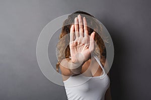 Young woman covering her face with palm