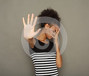 Young woman covering her face with palm