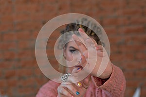 Young woman covering her face with palm saying no. Girl denying proposal, making stop gesture with her hand. Studio shot