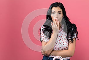 Young woman covering her mouth