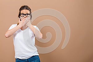 Young woman covering her mouth