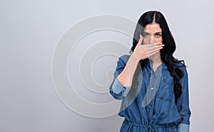 Young woman covering her mouth