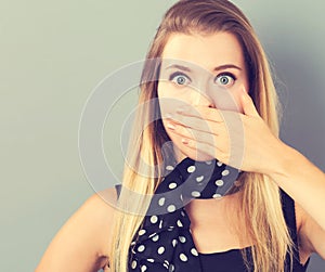 Young woman covering her mouth