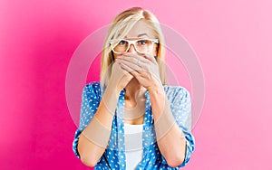 Young woman covering her mouth