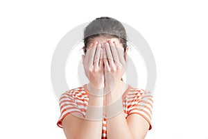 Young woman covers her face with hands