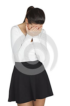 Young woman covers her face with her hands in grief