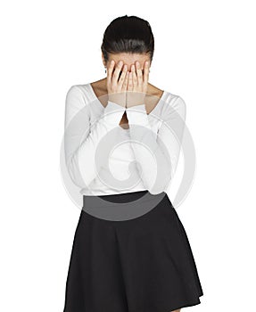 Young woman covers her face with her hands in grief