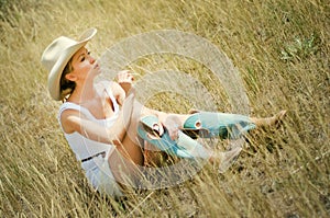 Young woman in a cowboy hat and boots