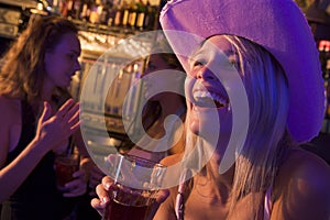 Young woman in cowboy hat laughing at a nightclub