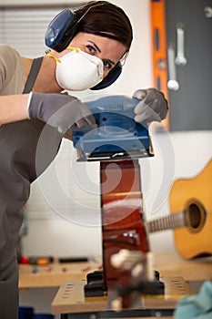 young woman crafting guitar