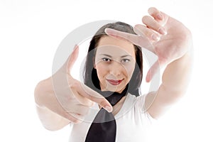 Young woman creates a frame with her hands