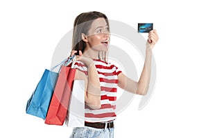Young woman with credit card and shopping bags on white. Spending money