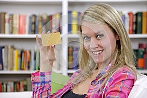 Young woman with credit card smiling