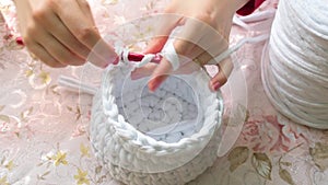 Young woman while crocheting, close up.