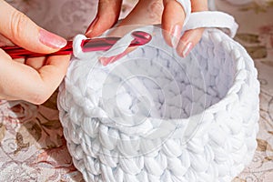 Young woman while crocheting, close up