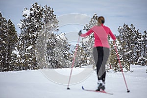 Young woman cross-country skiing on a winter day