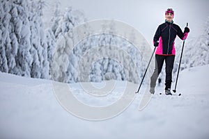 Young woman cross-country skiing on a winter day