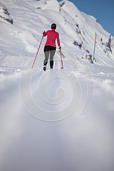 Young woman cross-country skiing on a winter day