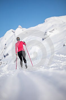 Young woman cross-country skiing on a winter day