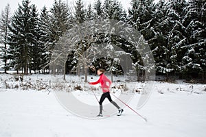 Young woman cross-country skiing on a  winter day