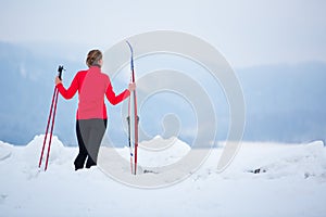 Young woman cross-country skiing on a  winter day