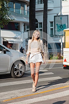 Young woman crosses the Boulevard de la Croisette photo