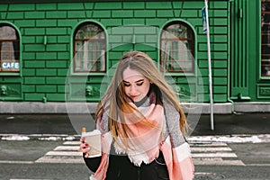 Young woman crossing city street in winter